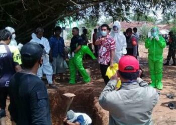 PEMAKAMAN: Terlihat masyarakat bersama Muspika Kronjo sedang melakukan proses pemakaman pasien di Tempat Pemakaman Umum Desa Pasilian, Kecamatan Kronjo, Kamis (27/8). (ISTIMEWA)